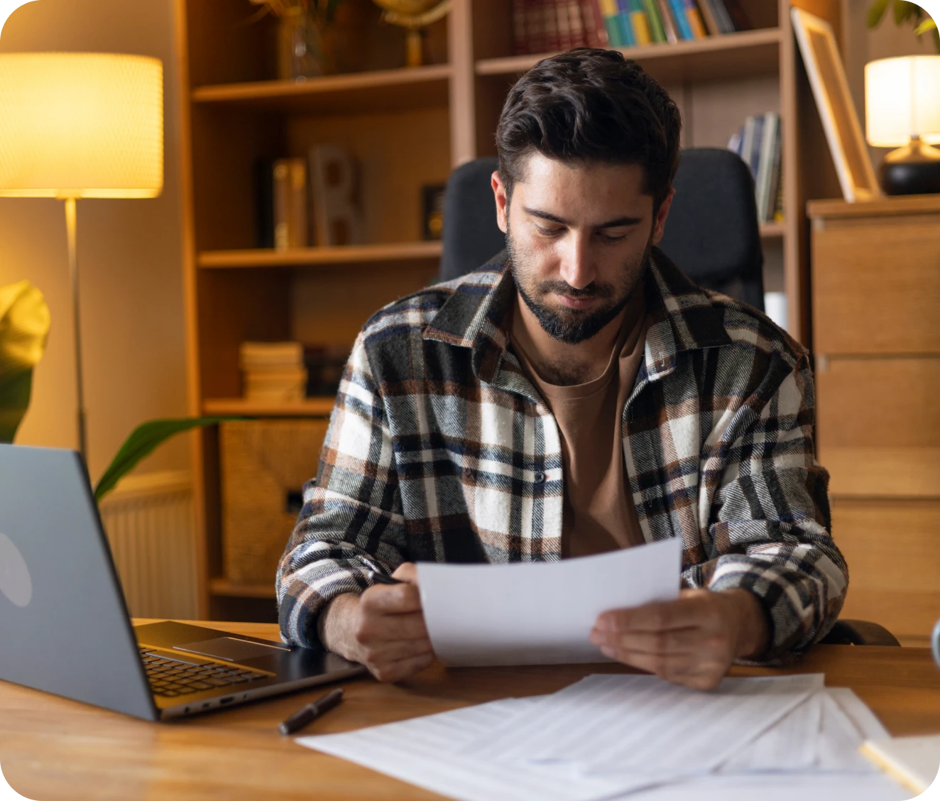 Person working with papers and laptop