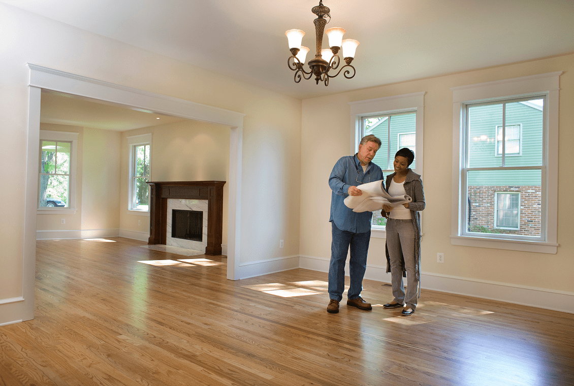 Spacious room with fireplace and hardwood floors